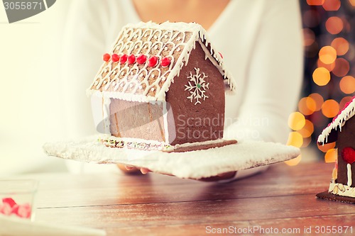 Image of close up of woman showing gingerbread house