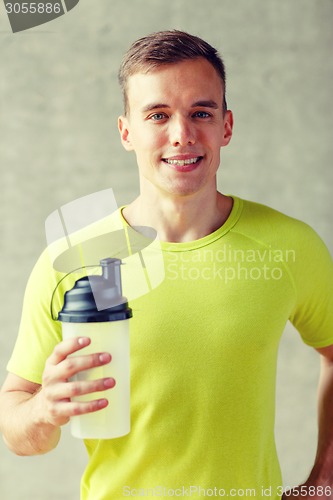 Image of smiling man with protein shake bottle