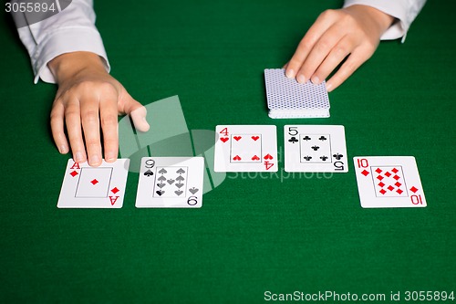 Image of holdem dealer with playing cards