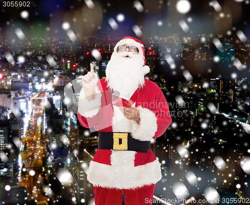 Image of man in costume of santa claus with notepad