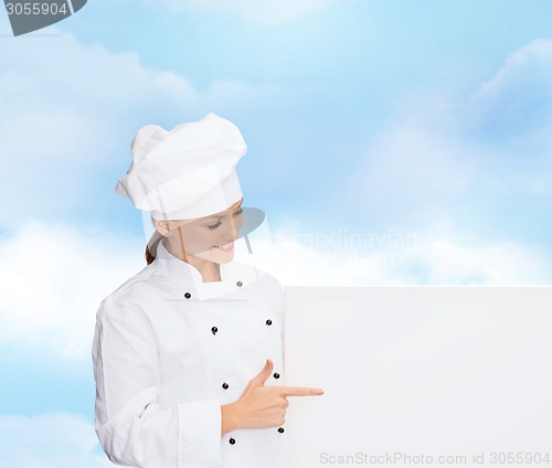 Image of smiling female chef with white blank board