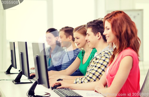 Image of female student with classmates in computer class