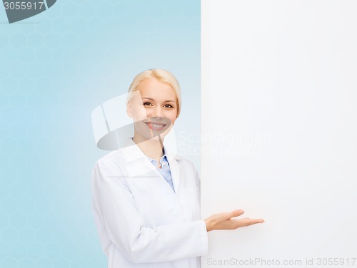 Image of smiling female doctor with white blank board