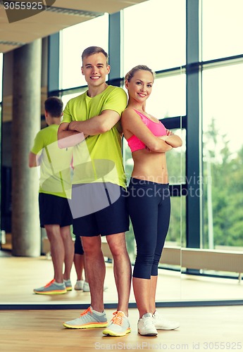 Image of smiling man and woman in gym