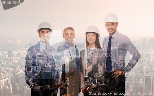 Image of happy businessmen in helmets over city background