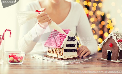 Image of close up of woman making gingerbread houses