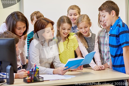 Image of group of school kids with teacher in classroom