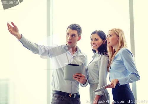 Image of business team working with tablet pcs in office