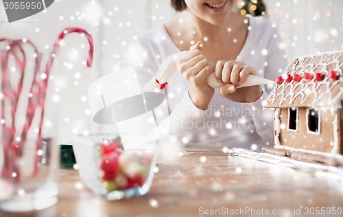 Image of close up of woman making gingerbread houses