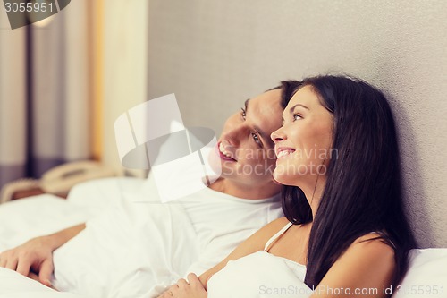 Image of happy couple dreaming in bed