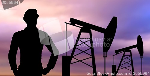 Image of black silhouette of oil worker and pump jack