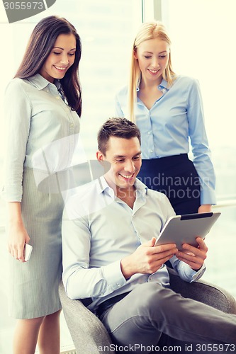 Image of business team working with tablet pc in office