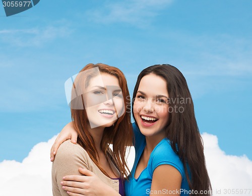 Image of smiling teenage girls hugging