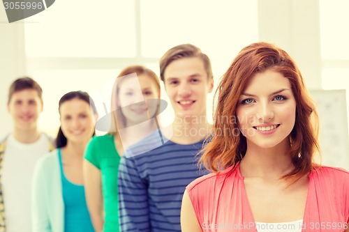 Image of smiling students with teenage girl in front