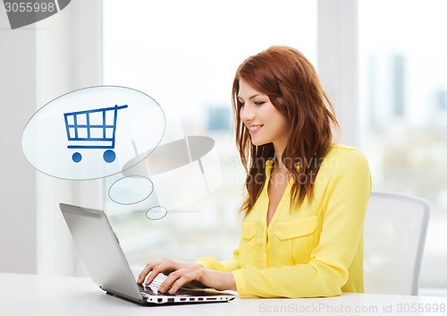 Image of smiling woman with laptop computer shopping online