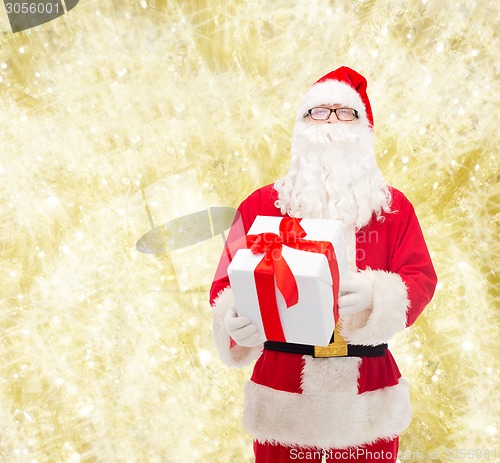 Image of man in costume of santa claus with gift box