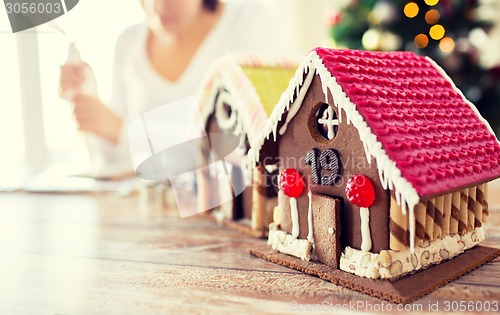 Image of close up of woman making gingerbread houses