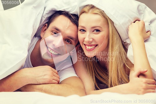 Image of happy couple sleeping in bed