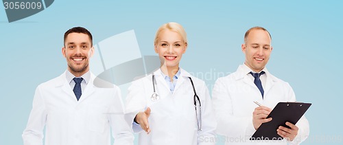 Image of group of doctors making handshake gesture