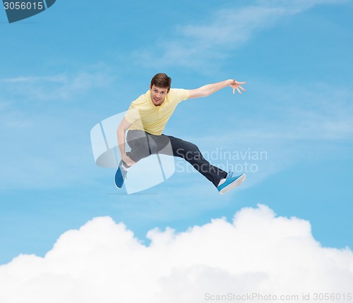 Image of smiling young man jumping in air