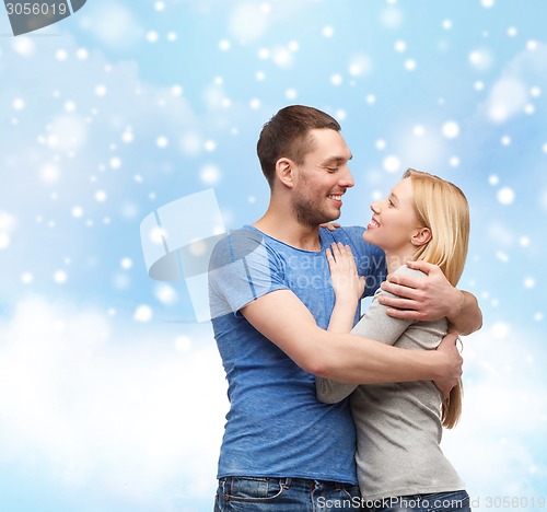 Image of happy couple hugging outdoors