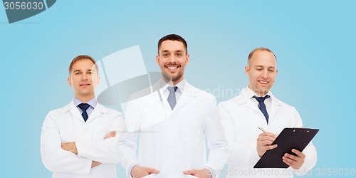 Image of group of smiling male doctors in white coats
