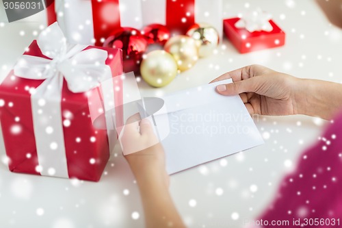 Image of close up of woman with letter and presents