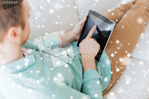 Image of close up of man with tablet pc computer at home