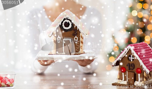 Image of close up of woman showing gingerbread house