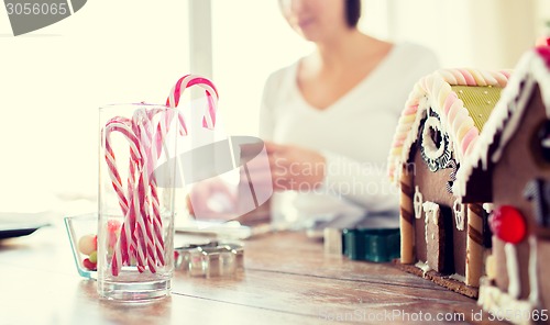 Image of close up of woman making gingerbread houses