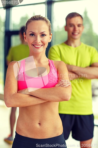 Image of smiling man and woman in gym