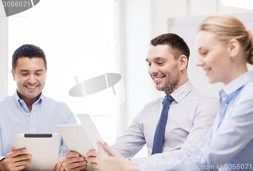 Image of business team working with tablet pc in office