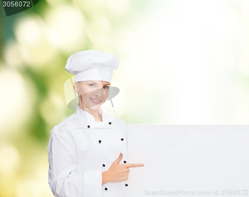 Image of smiling female chef with white blank board