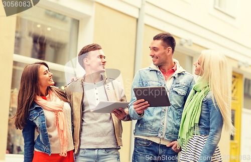 Image of group of smiling friends with tablet pc computers