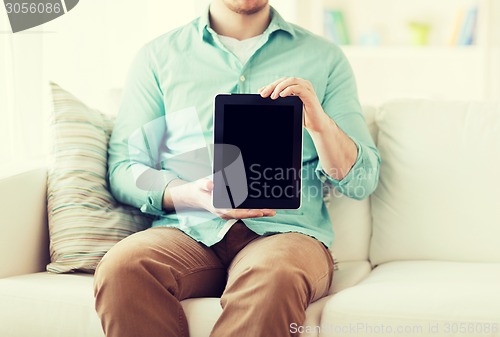 Image of close up of man with tablet pc computer at home