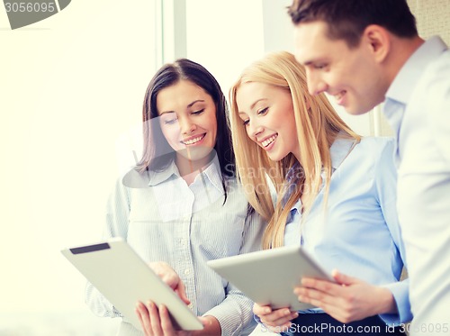 Image of business team working with tablet pcs in office