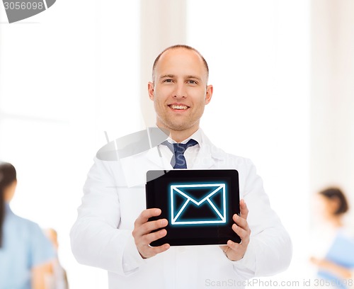 Image of smiling male doctor with tablet pc