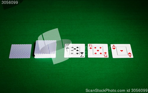 Image of playing cards on green table surface