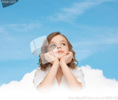 Image of beautiful girl sitting at table and looking up