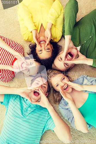 Image of smiling people lying down on floor and screaming