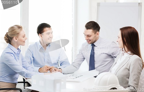 Image of happy team of architects and designers in office