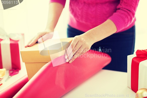 Image of close up of woman decorating christmas presents