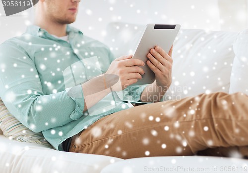 Image of close up of man with tablet pc computer at home