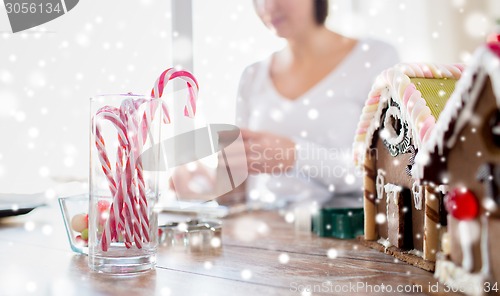 Image of close up of woman making gingerbread houses