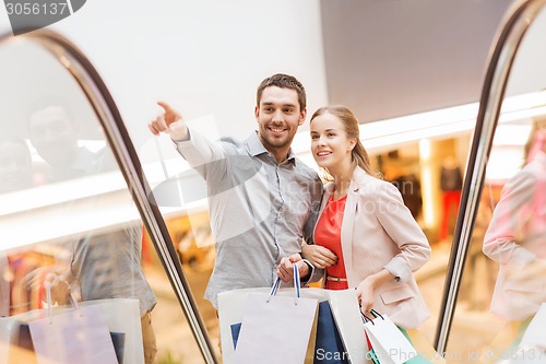 Image of happy young couple with shopping bags in mall