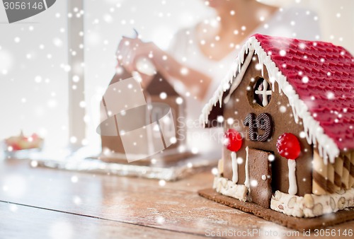 Image of close up of woman making gingerbread houses