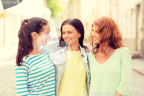 Image of smiling teenage girls with on street