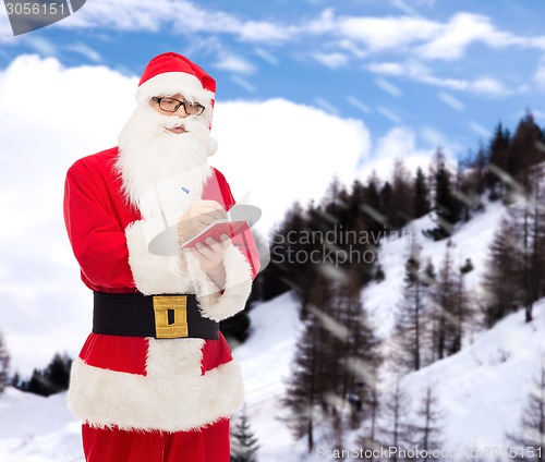 Image of man in costume of santa claus with notepad