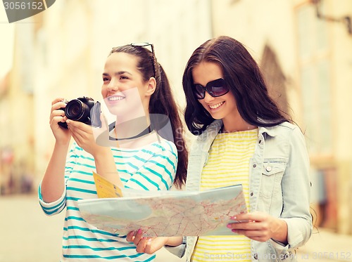 Image of smiling teenage girls with map