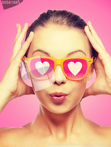 Image of surprised teenage girl in pink sunglasses